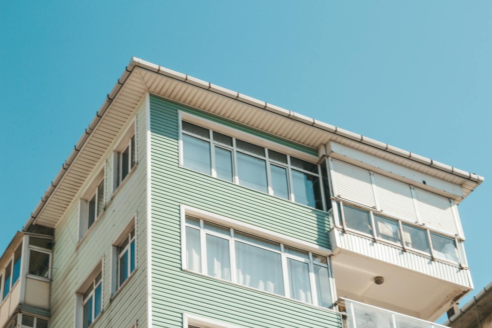 Low angle view of a modern apartment building exterior with flat roof