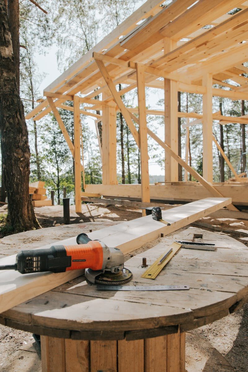 A scenic view of woodworking tools and wooden frame at a construction site.