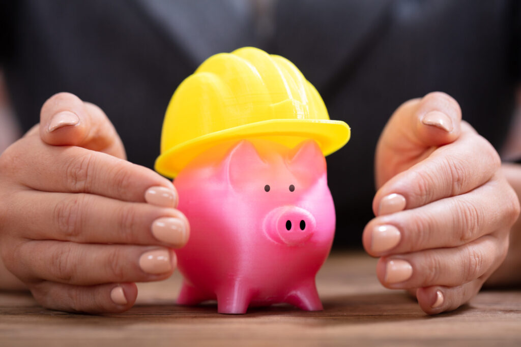 Piggy bank wearing a builder's hat
